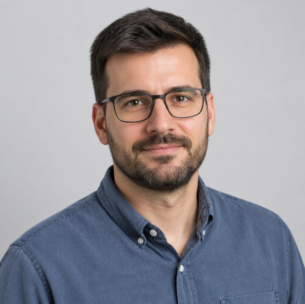 Studio portrait of a man with a beard and glasses