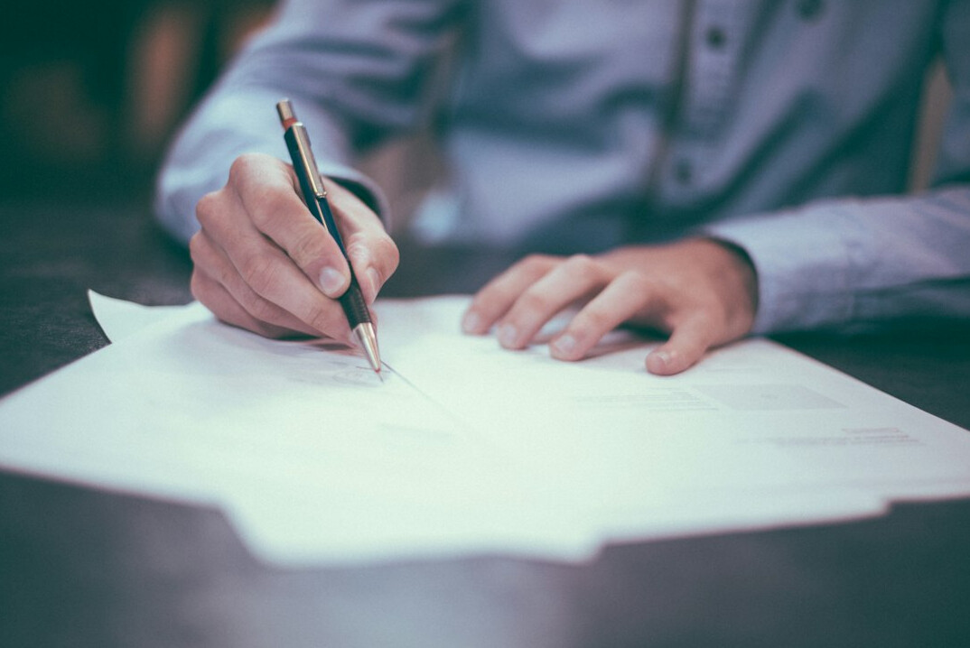 person reviewing notes on paper